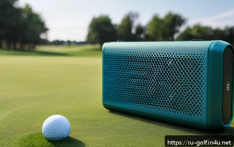 휴대용 골프 스피커 추천 - A high-resolution image of a sleek, portable Bluetooth speaker placed on a golf course next to a gol...